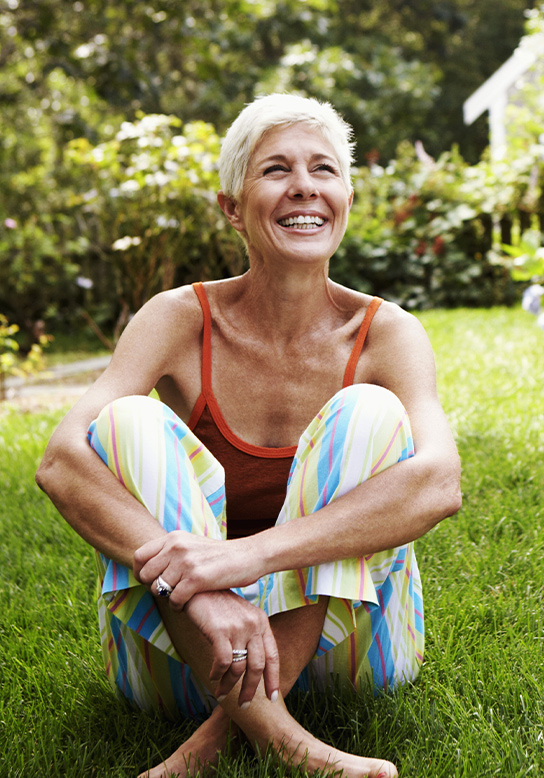 woman sitting on grass smiling 